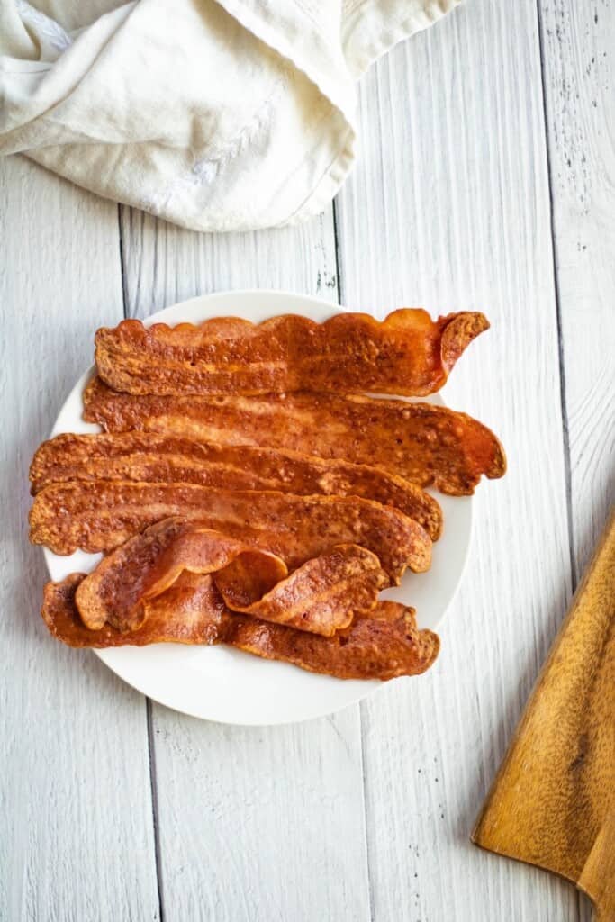 Air Fryer Turkey Bacon on a white plate from overhead