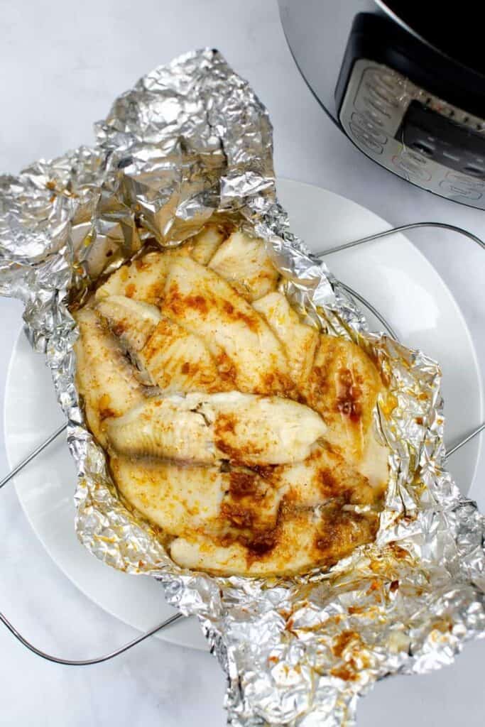 Instant Pot Tilapia with seasoning on top of aluminum foil