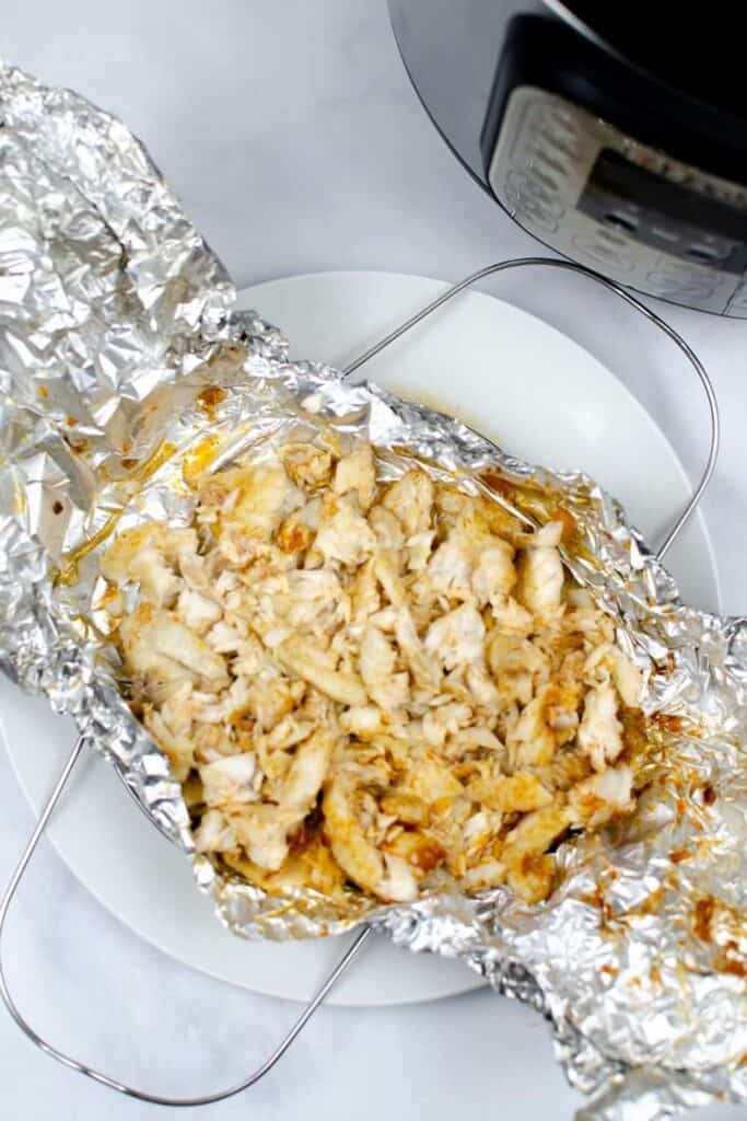 Instant Pot Tiliapia shredded on top of aluminum foil