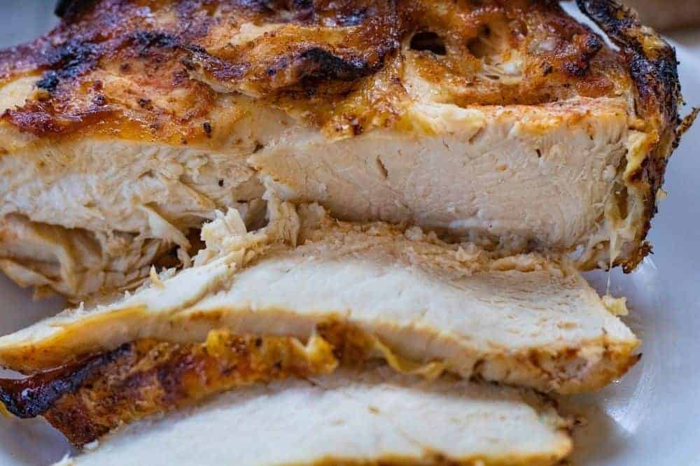 Closeup of air fryer bone-in chicken breasts cut into slices