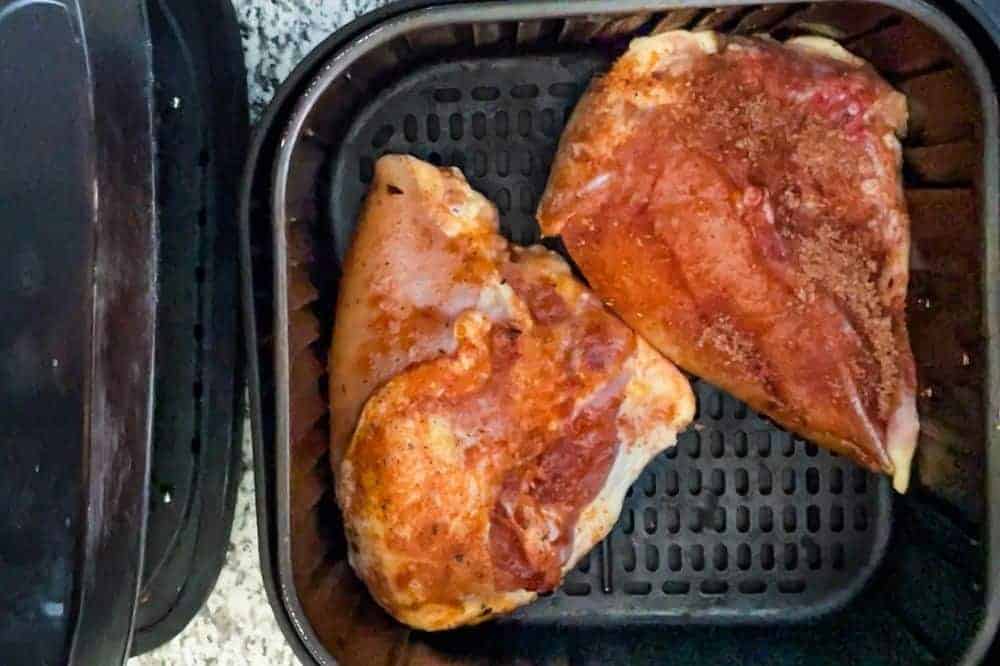 Raw bone-in soit chicken breasts in the air fryer