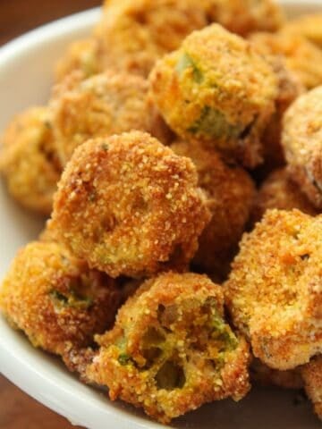 Close up of air fryer okra breaded and in a small bowl.