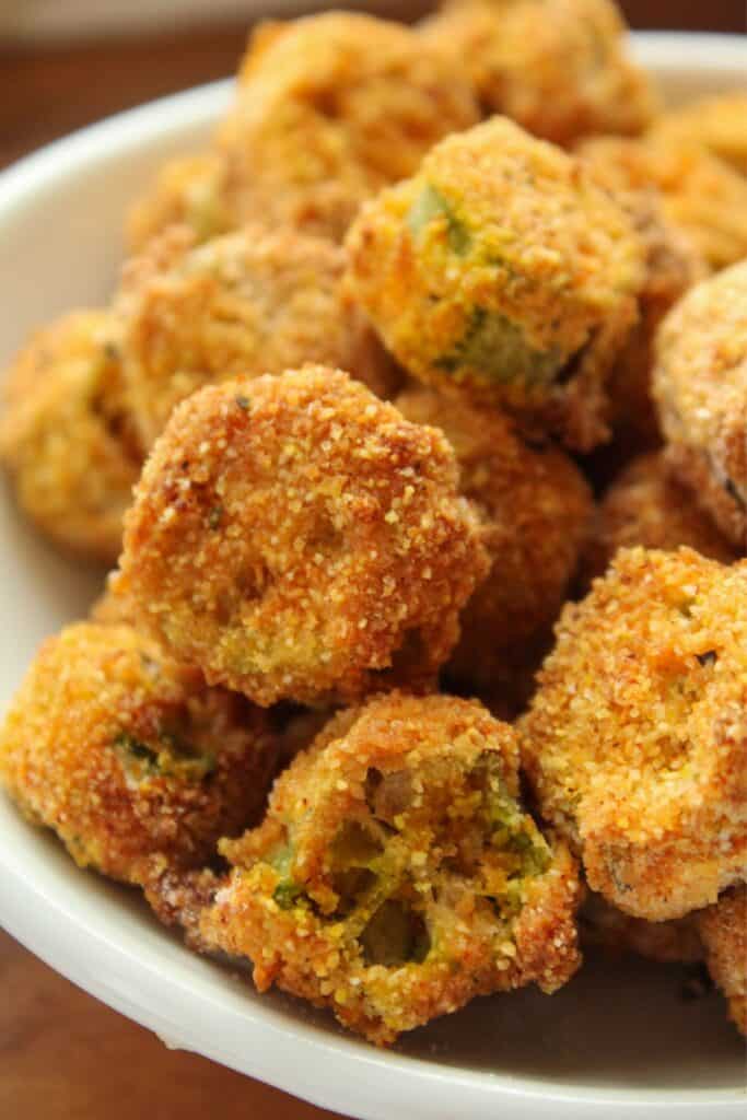 Close up of air fryer okra breaded and in a small bowl.