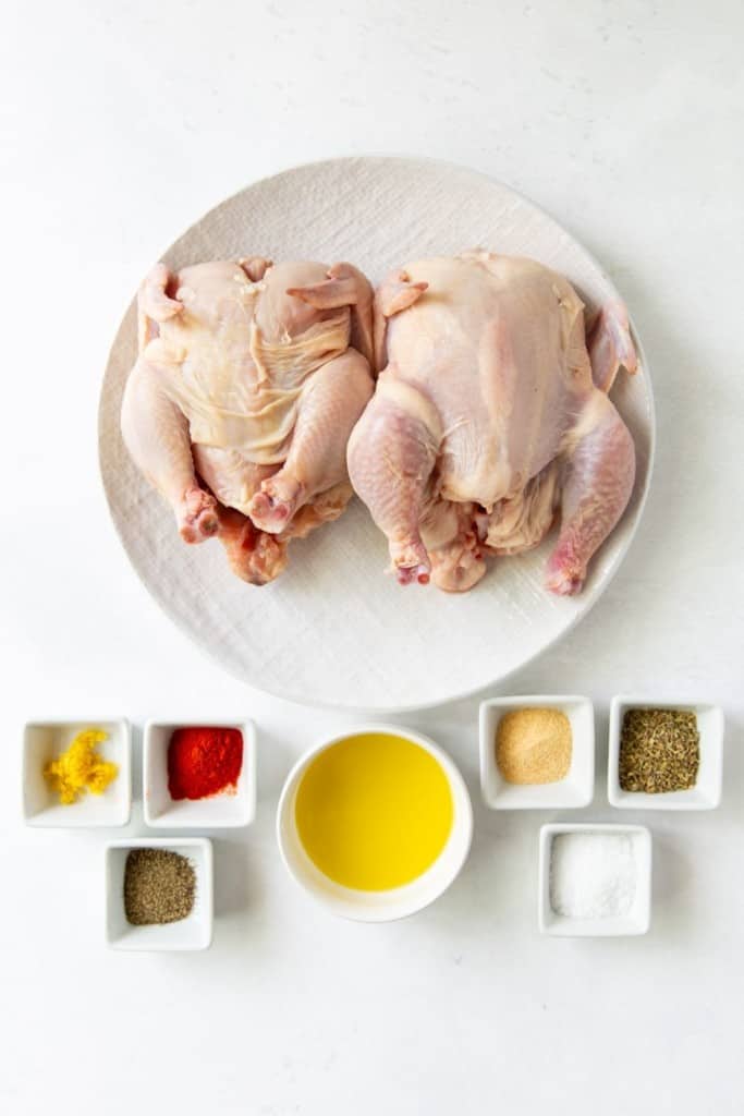 Ingredients needed to make cornish hen in the air fryer on a white background