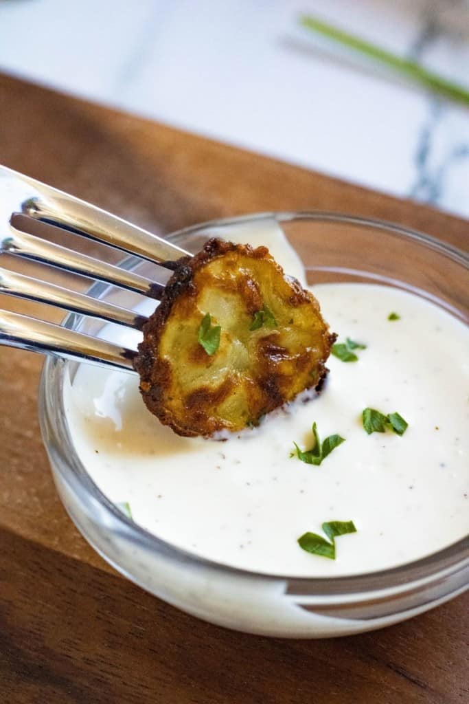 Potato being dipped into ranch dressing