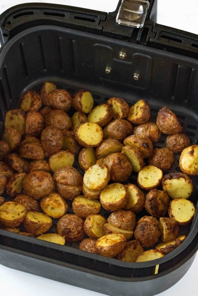 Cooked ranch potatoes inside air fryer basket