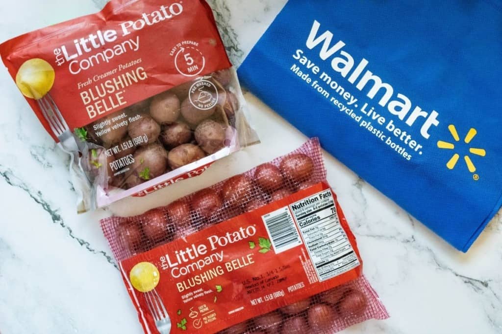 Walmart bag with two bags of Blushing Belle potatoes from The Little Potato Company (one in a mesh bag and one in a plastic bag)
