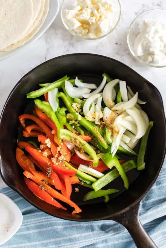 Peppers and onions inside cast iron skillet