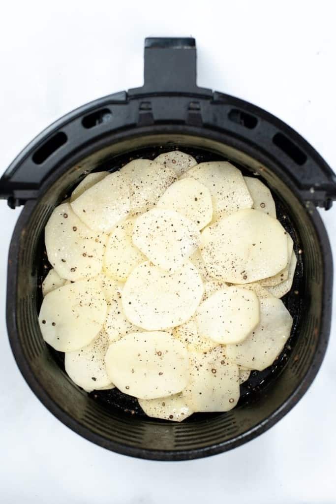Raw potato chips inside air fryer