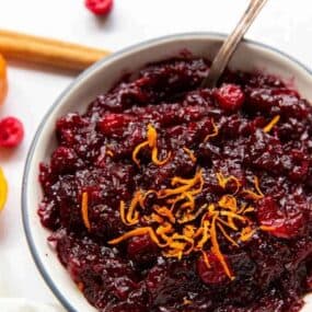 Cranberry Orange Sauce in a bowl with orange zest on top