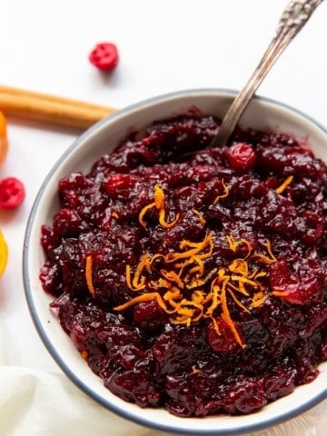 Cranberry Orange Sauce in a bowl with orange zest on top