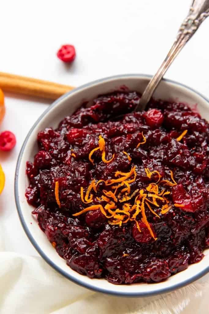 Cranberry Orange Sauce in a bowl with orange zest on top 