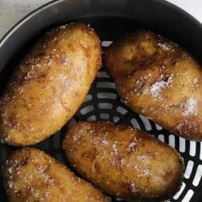 Baked potatoes inside Ninja Foodi air fryer basket