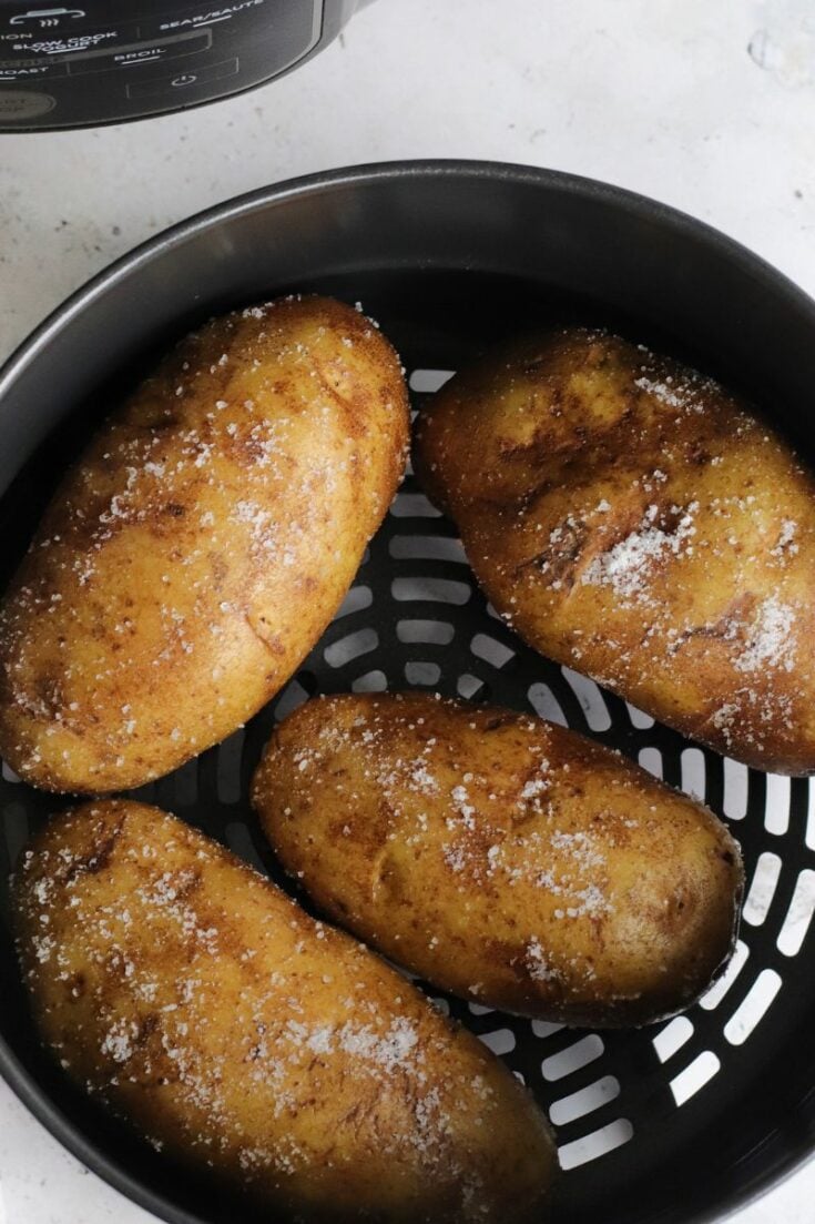 Baked potatoes inside Ninja Foodi air fryer basket