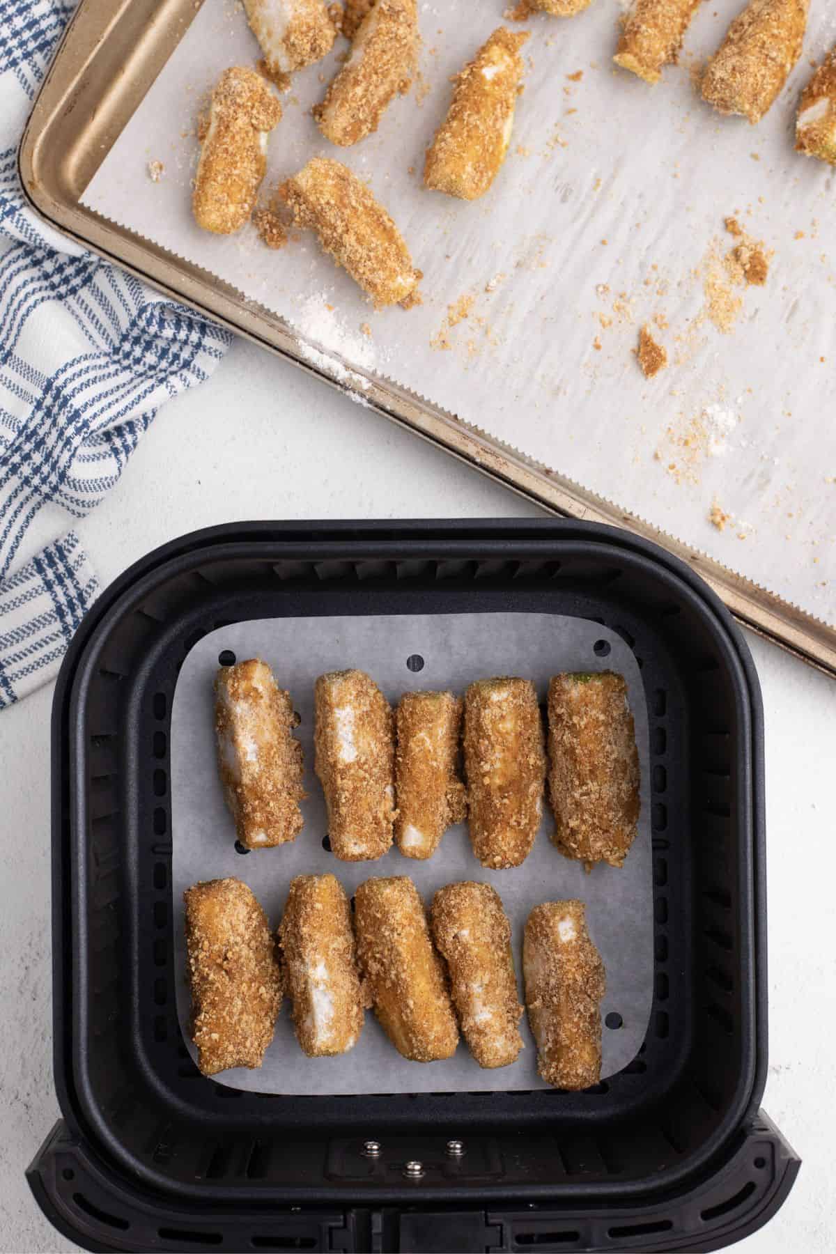 graham cracker coated apples in an air fryer basket.