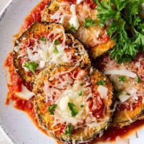 Air Fryer Eggplant Parm cutlets on a white plate