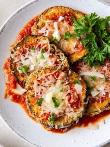 Air Fryer Eggplant Parm cutlets on a white plate