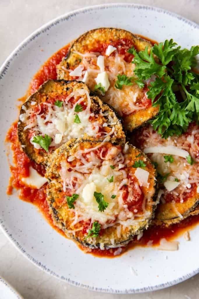 Air Fryer Eggplant Parm cutlets on a white plate 