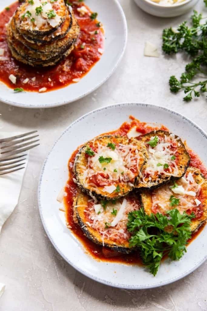 Air Fryer Eggplant parmesan on a two different white plates 