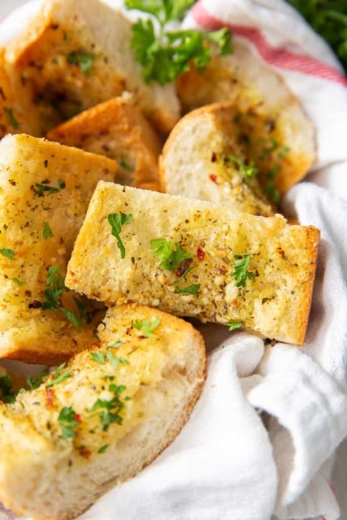 Closeup of garlic bread slices inside a basket