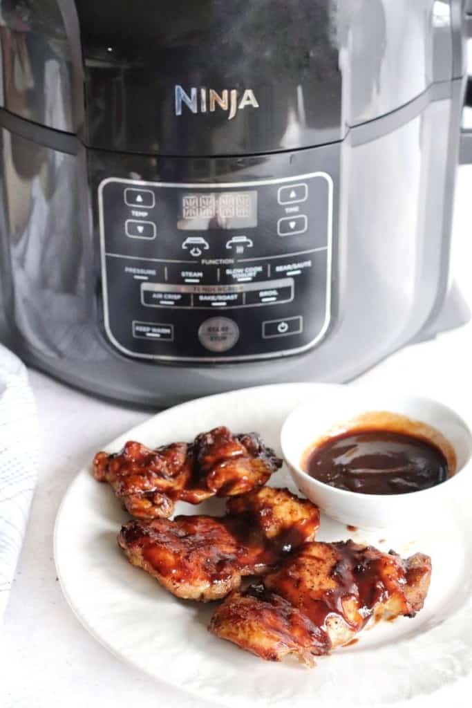 Chicken thighs in front of the Ninja air fryer machine