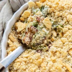 Green Bean Casserole in a round casserole dish with a serving spoon inside