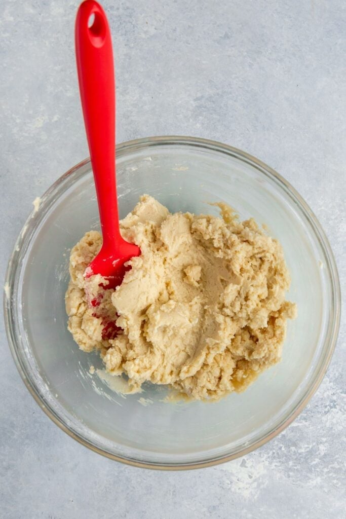 Easy thumbprint cookies recipe in a mixing bowl with a rubber spatula.