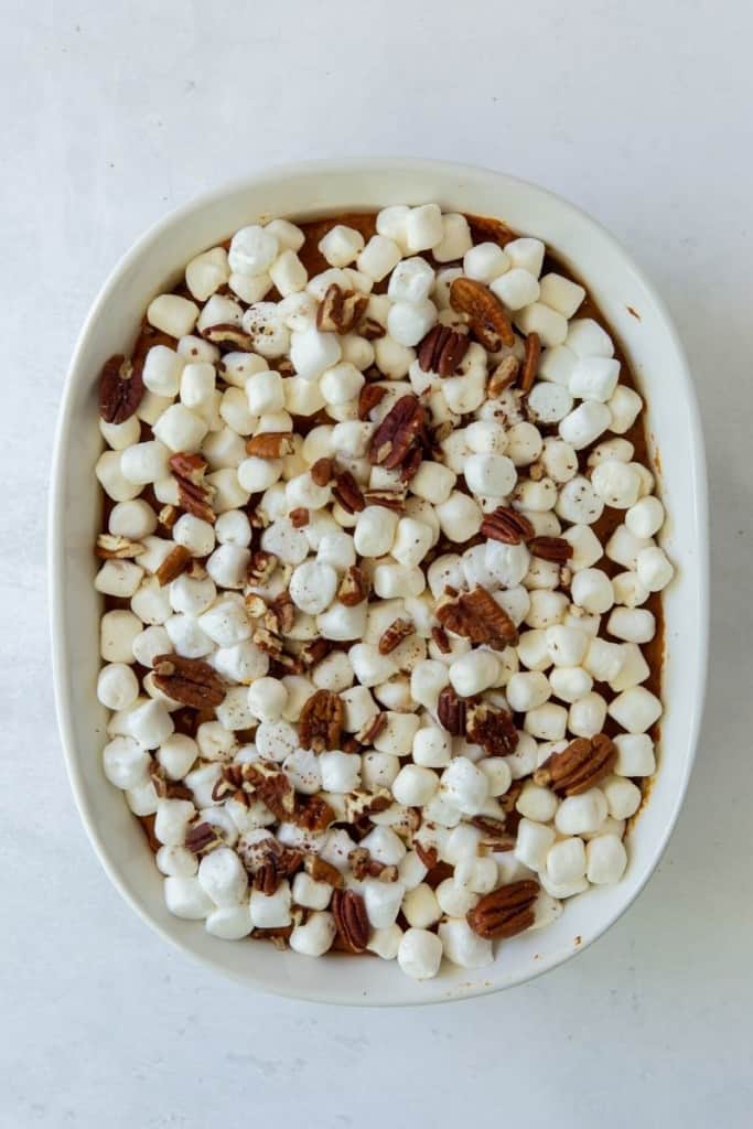 Casserole dish with marshmallows and pecans on top uncooked