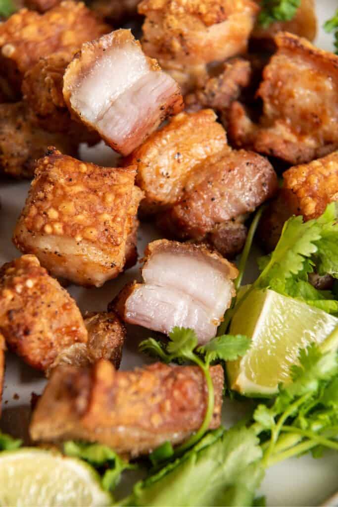 Close up of air fryer pork belly that is golden brown to show the crispiness.