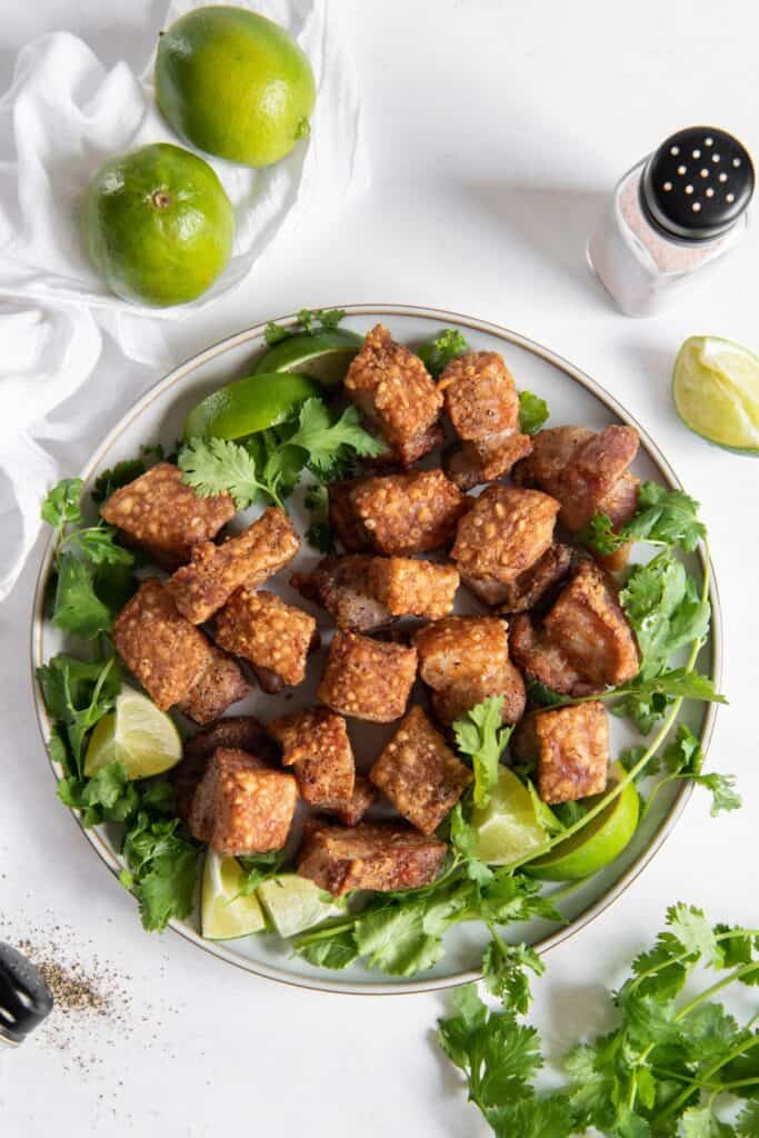 Air fryer pork belly on a plate with some lettuce.