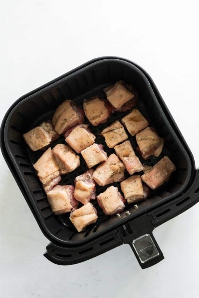 Raw pork belly in air fryer basket