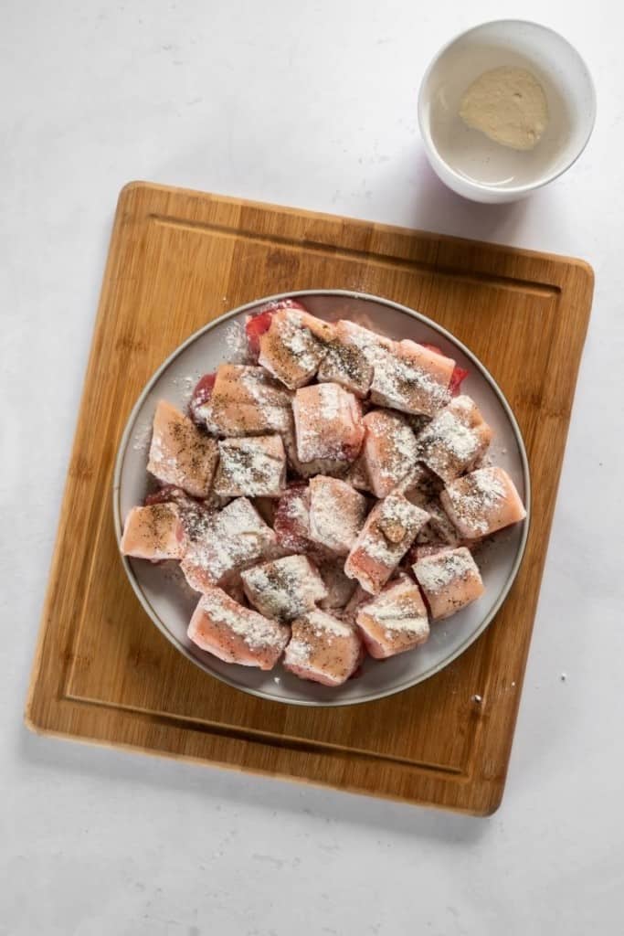 Pork Belly on a plate with baking powder and garlic powder on top