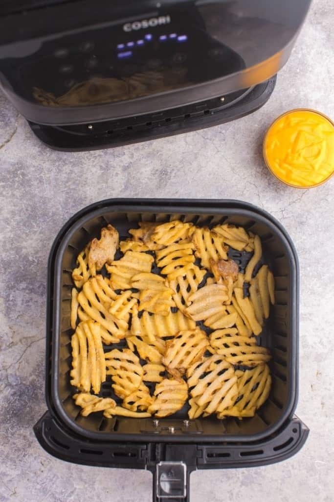 Frozen waffle fries in air fryer basket