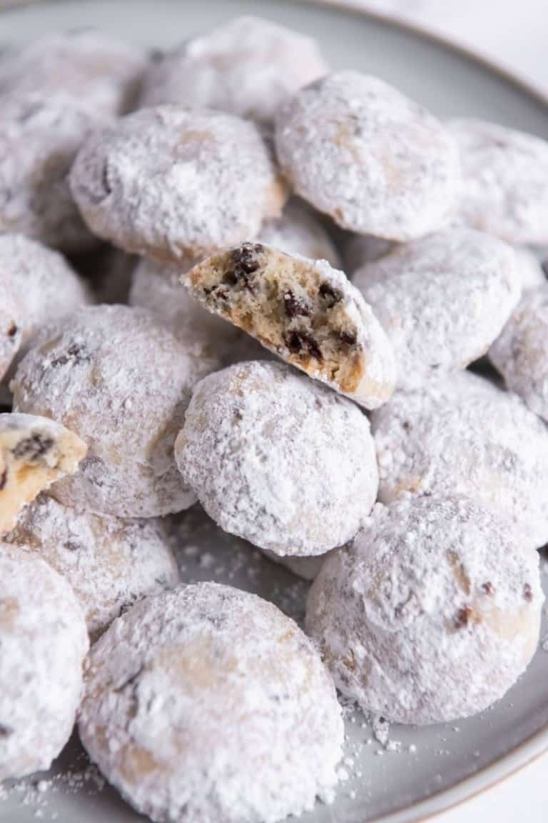 Snowball Cookies with Chocolate chips served on a grey round plate