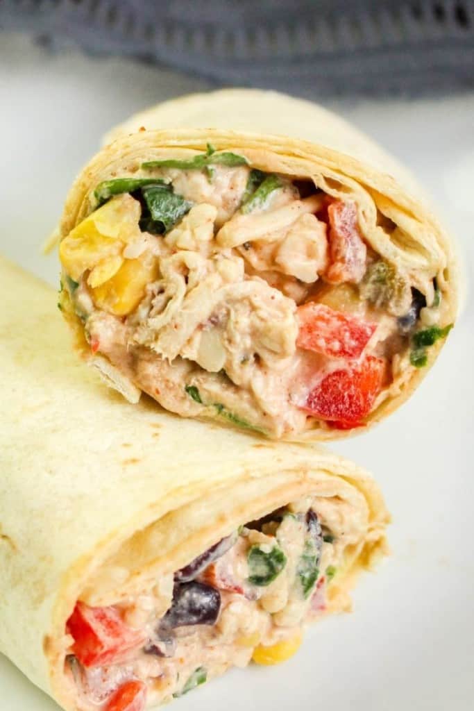 Closeup of southwest chicken wrap halves leaned on top of each other