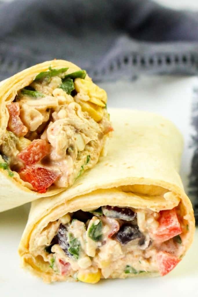 Chicken wrap halves on top of a white plate