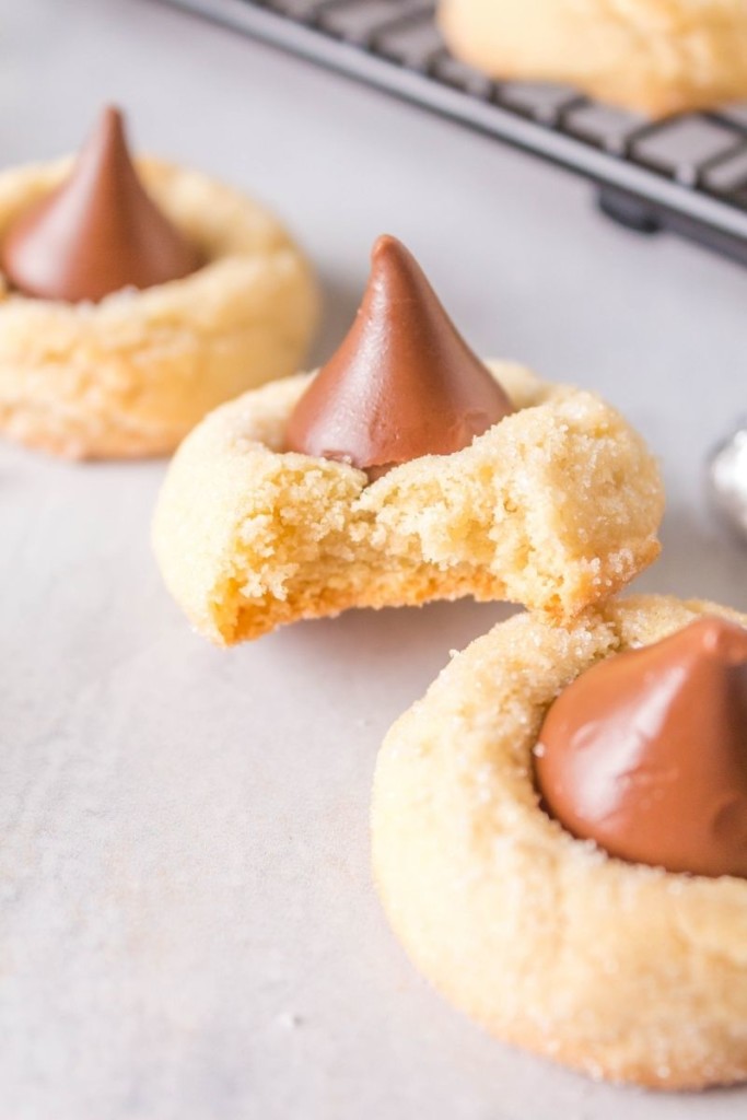 Hershey Kiss Cookies with shortbread with one bitten into so you can see the inside of the soft chewy cookie