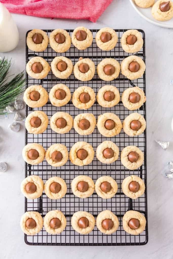 Hershey Cookies Without Peanut Butter on a wire rack with wrapped kisses around it