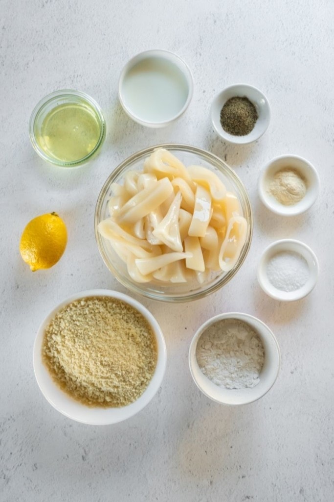 Ingredients needed to make air fryer calamari rings in separate bowls