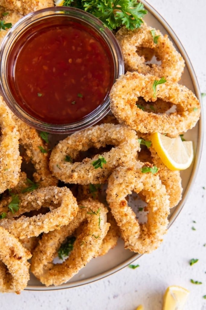 Air Fryer Calamari served on a plate with sweet chili sauce