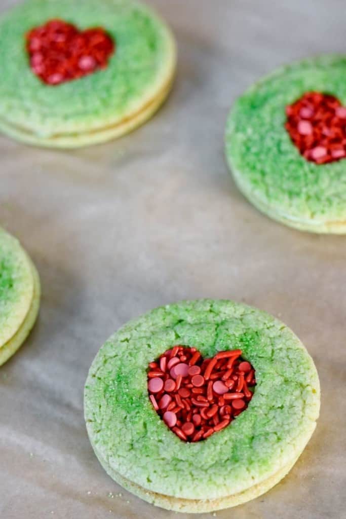 Grinch sugar cookies with heart-shaped cut out
