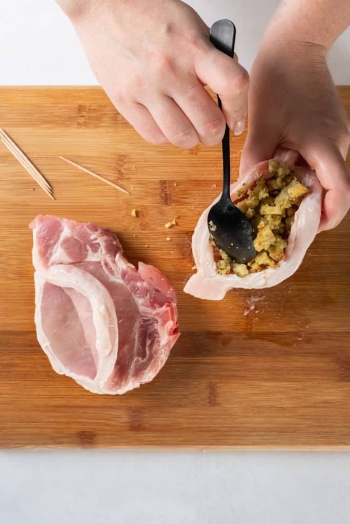 Stuffing the pork chops with stovetop dressing