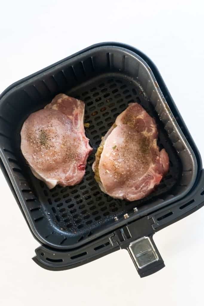 Raw stuffed pork chops in air fryer basket