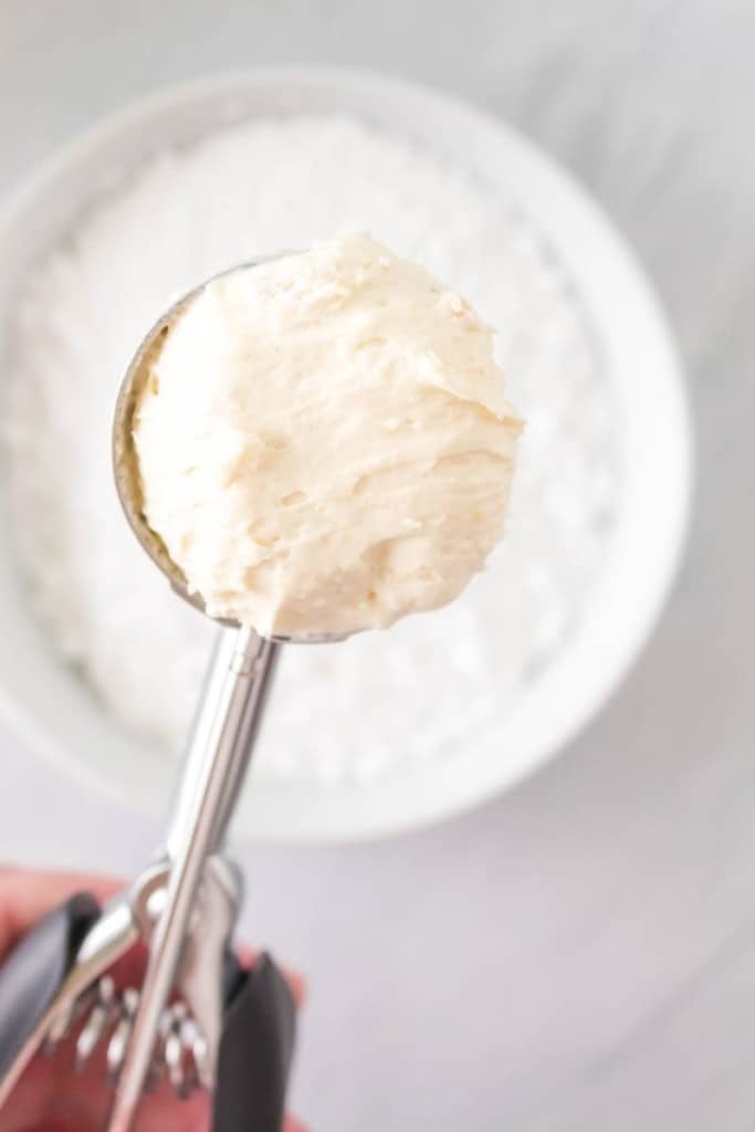 scoop the dough into a bowl of powdered sugar