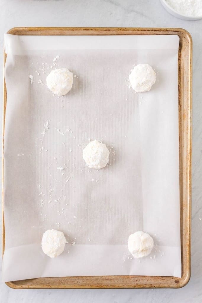 place balls of dough on prepared cooking sheet with 1 1/2 inches between each