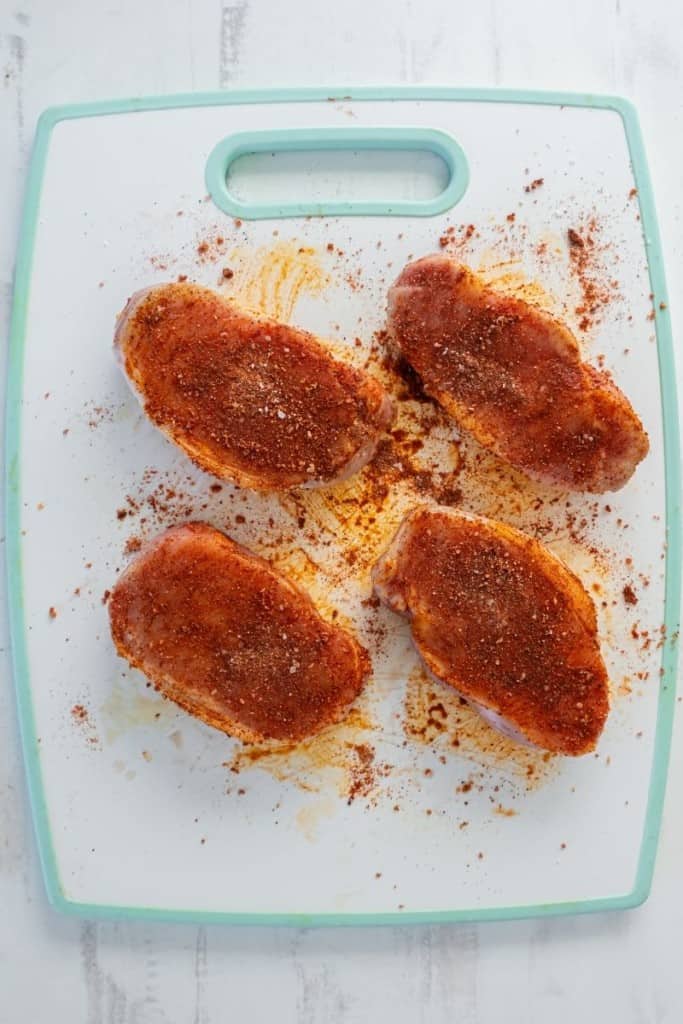 spread dry rub onto pork chops