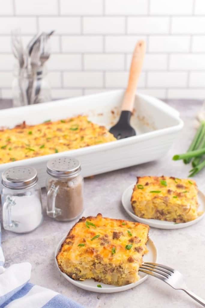 hash brown casserole in 9 by 13 dish with two plates with servings