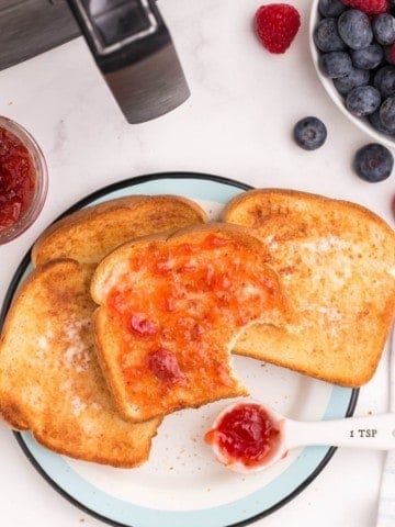 Slices of air fryer toast with jam on a plate