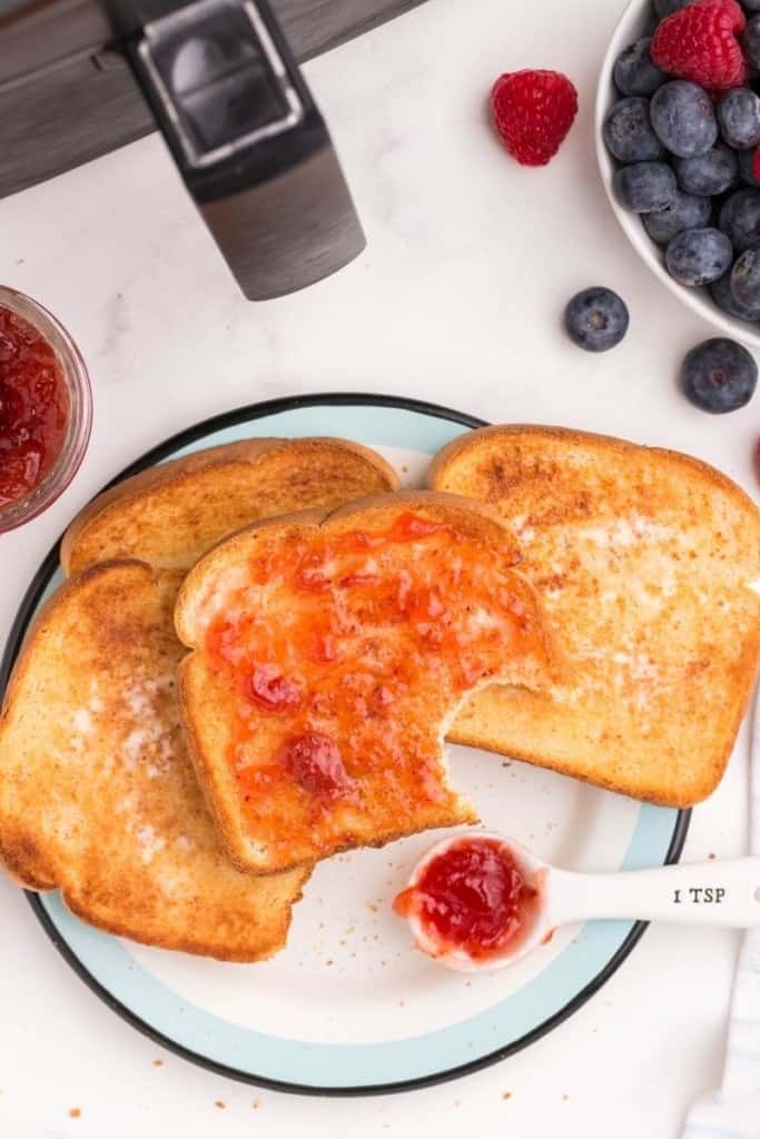 Slices of air fryer toast with jam on a plate