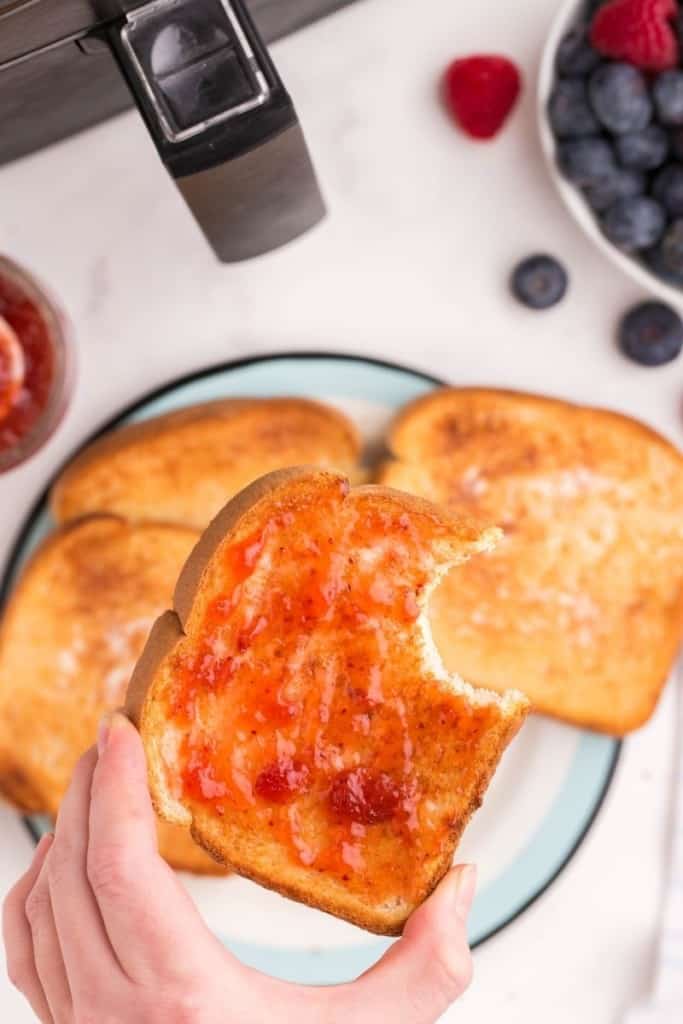 slices of air fryer toast on plate with butter and jam